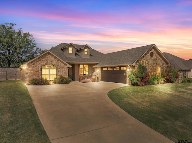 view of front of house with a garage and a lawn