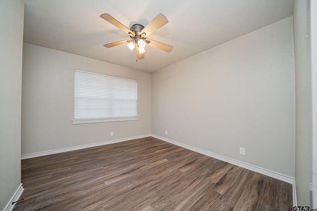 spare room with ceiling fan and dark wood-type flooring