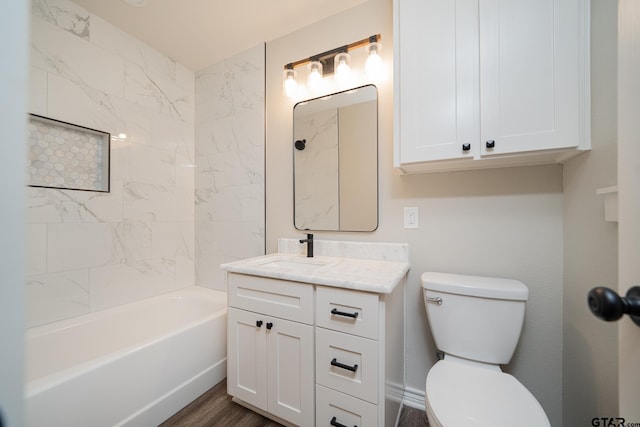 full bathroom featuring hardwood / wood-style flooring, toilet, vanity, and tiled shower / bath combo