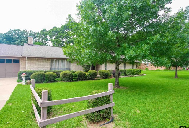 107 Clover Dr, Gun Barrel City, TX 75156 - view of front facade with brick siding, concrete driveway, a garage, a chimney, and a shingled roof