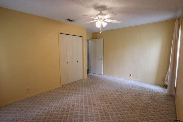 107 Clover Dr, Gun Barrel City, TX 75156 - unfurnished bedroom with carpet floors, a textured ceiling, a closet, baseboards, and a ceiling fan