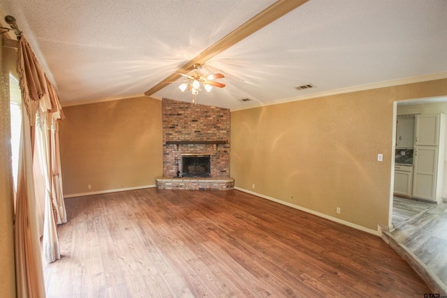 107 Clover Dr, Gun Barrel City, TX 75156 - unfurnished living room with ceiling fan, light wood-style flooring, a fireplace, lofted ceiling, and baseboards