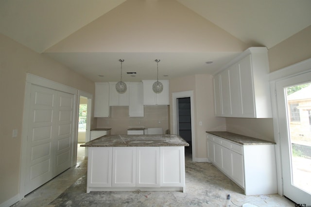 1209 S Butler Ave, Tyler, TX 75701 - kitchen with a center island, lofted ceiling, healthy amount of natural light, and white cabinetry
