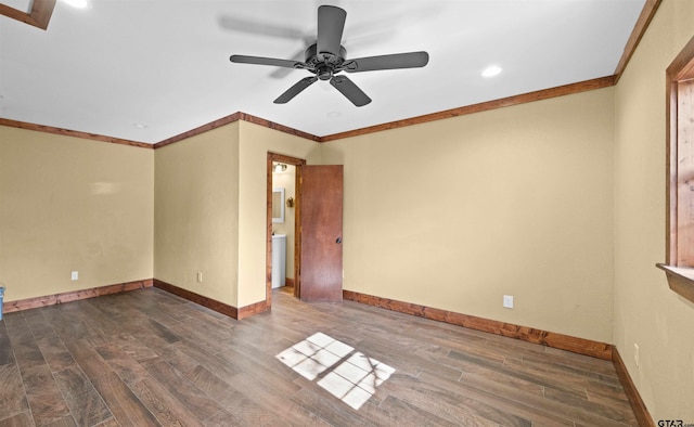 empty room with ceiling fan, dark wood-type flooring, and ornamental molding