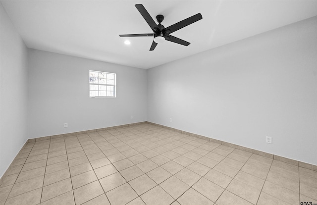 tiled spare room with ceiling fan