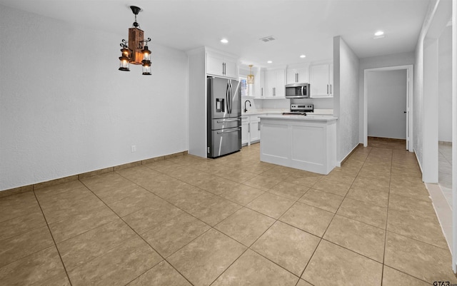 kitchen with pendant lighting, white cabinets, stainless steel appliances, sink, and light tile patterned floors