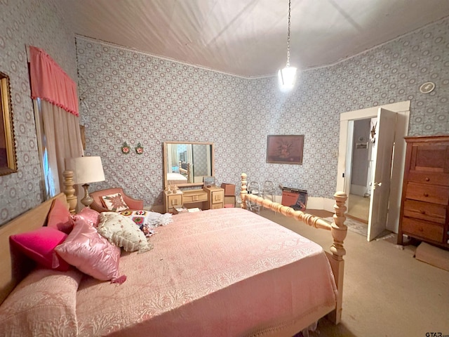 bedroom with carpet floors and wallpapered walls