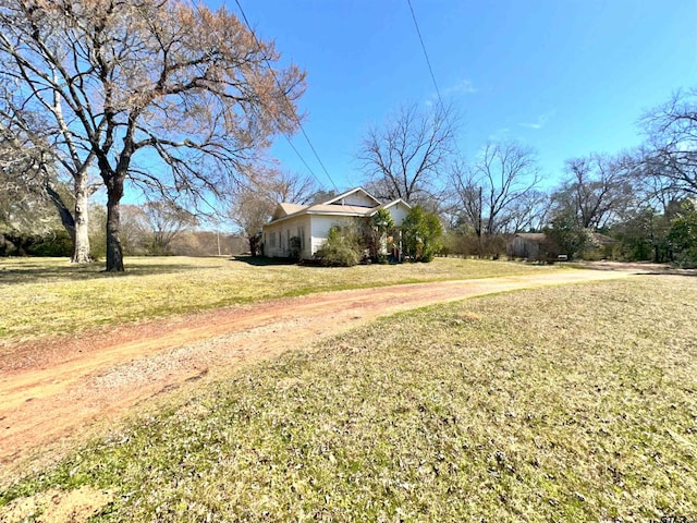 view of yard with dirt driveway