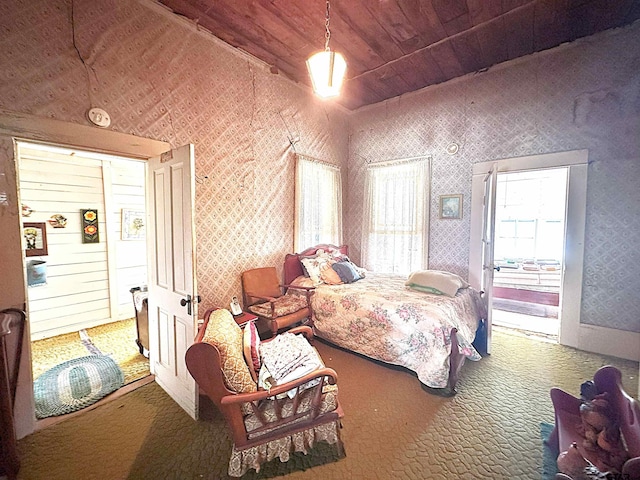 carpeted bedroom featuring wooden ceiling, vaulted ceiling, and wallpapered walls