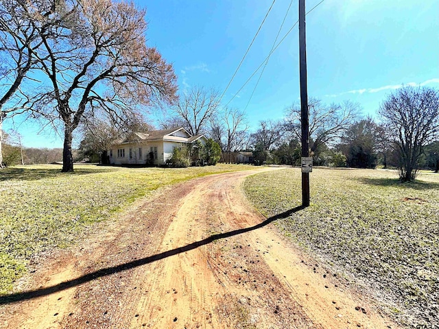 view of street with dirt driveway