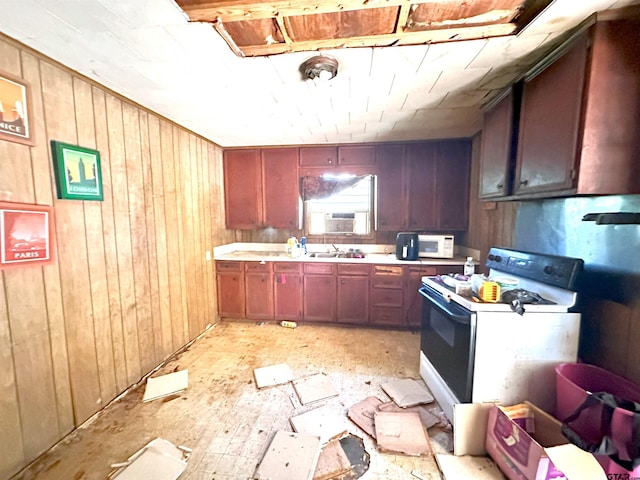 kitchen featuring light countertops, white appliances, and wooden walls