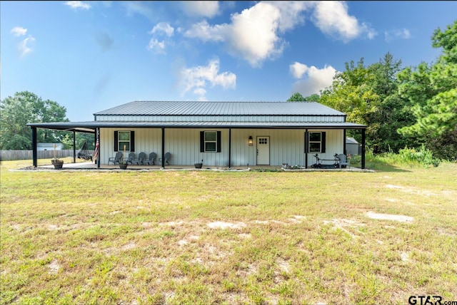 rear view of house with a porch and a lawn