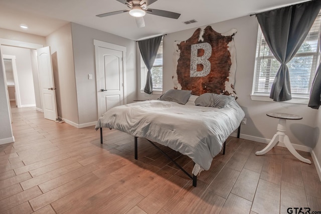 bedroom with light wood-type flooring and ceiling fan