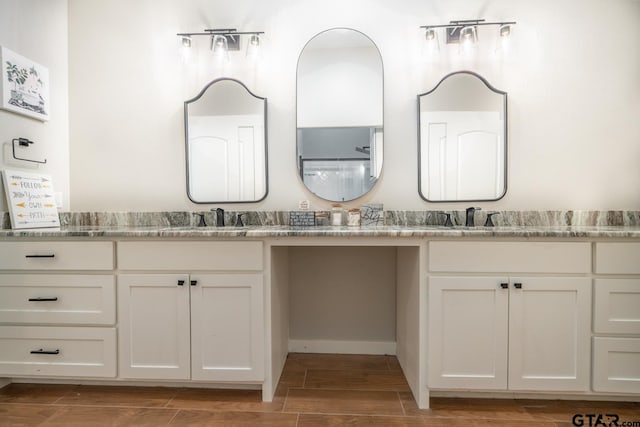 bathroom with wood-type flooring and vanity
