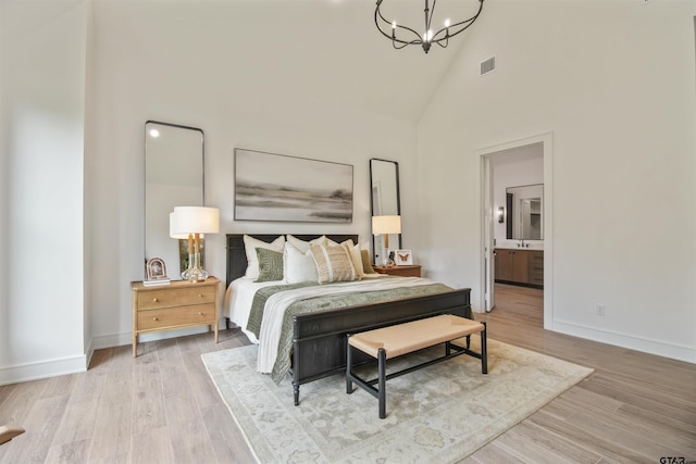 3312 Forest Ct, Tyler, TX 75703 - bedroom featuring a chandelier, high vaulted ceiling, baseboards, wood finished floors, and ensuite bath