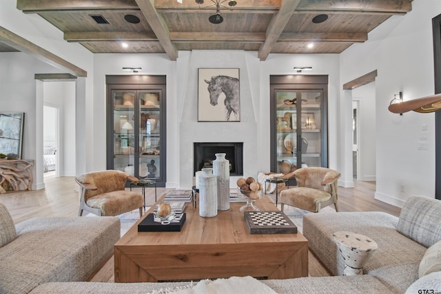 3312 Forest Ct, Tyler, TX 75703 - living area featuring wooden ceiling with exposed beams, light wood-style floors, baseboards, a large fireplace, and coffered ceiling