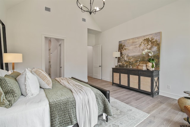 3312 Forest Ct, Tyler, TX 75703 - bedroom with a chandelier, high vaulted ceiling, wood finished floors, and baseboards