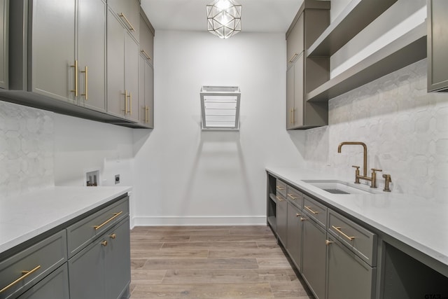 3312 Forest Ct, Tyler, TX 75703 - laundry room featuring cabinet space, hookup for an electric dryer, baseboards, and light wood-type flooring