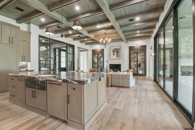 3312 Forest Ct, Tyler, TX 75703 - kitchen with a sink, light wood-type flooring, open floor plan, wood ceiling with exposed beams, and a kitchen island with sink