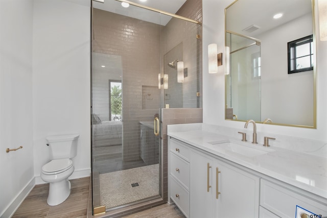 3312 Forest Ct, Tyler, TX 75703 - full bath with vanity, toilet, wood finished floors, a shower stall, and baseboards
