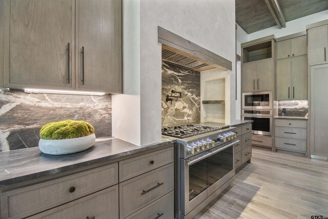 3312 Forest Ct, Tyler, TX 75703 - kitchen with stainless steel appliances, backsplash, beam ceiling, and light wood-type flooring