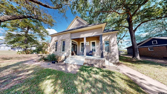 view of front of home with a porch and a front lawn