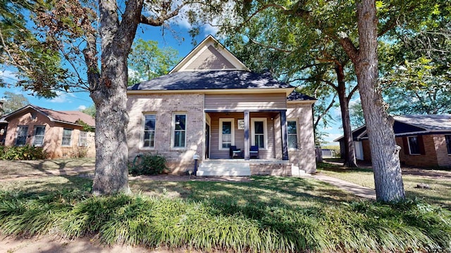 view of front facade featuring a front yard and covered porch