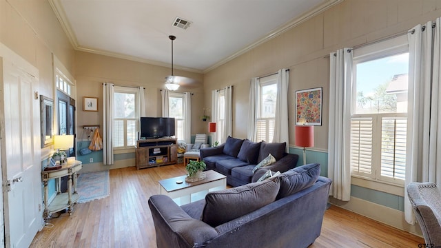 living room with ornamental molding and light hardwood / wood-style floors