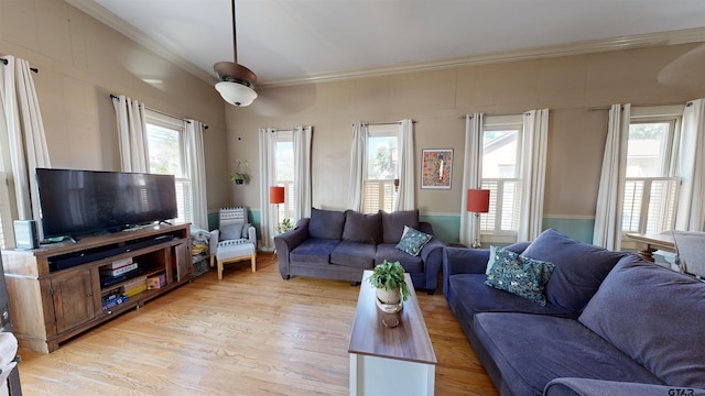 living room with light hardwood / wood-style floors, ceiling fan, and crown molding