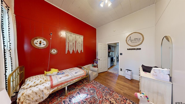 bedroom with hardwood / wood-style floors and vaulted ceiling