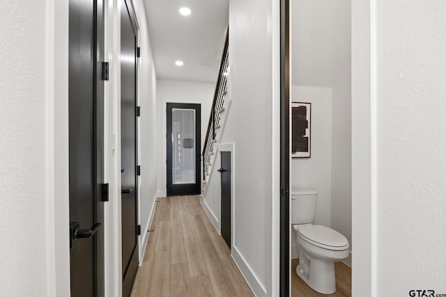 hallway with light hardwood / wood-style flooring