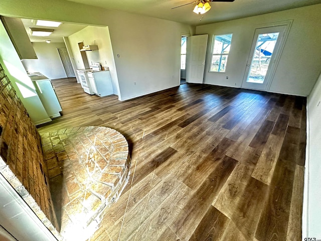 living room with a skylight, hardwood / wood-style flooring, and ceiling fan