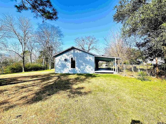 exterior space featuring a carport and a lawn