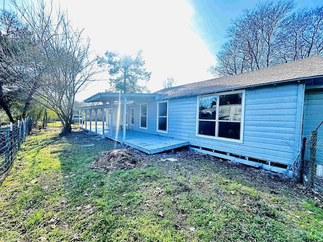 rear view of house featuring a yard and a patio