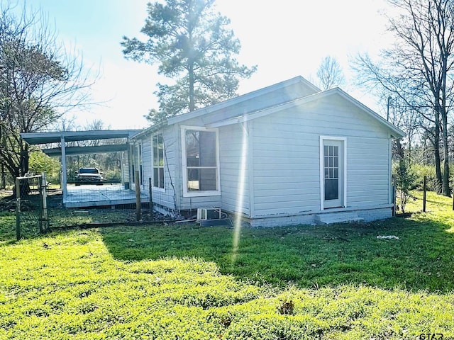 view of side of property with a yard