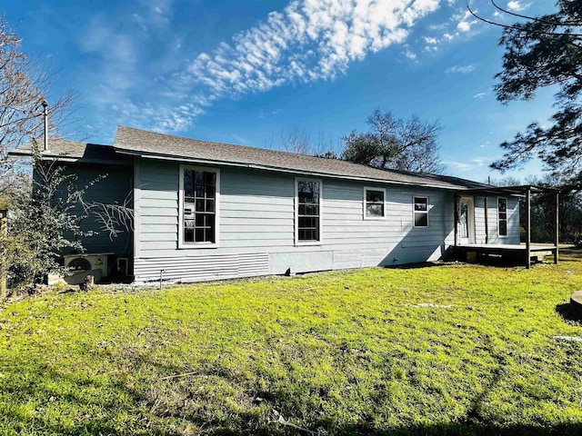 rear view of property with a yard