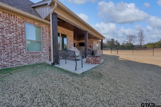 exterior space with an outdoor fire pit and a patio area