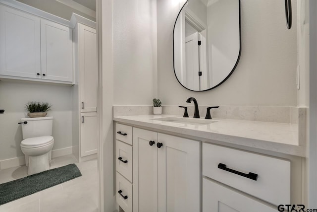 bathroom featuring tile patterned floors, vanity, and toilet