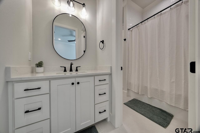 bathroom featuring shower / bathtub combination with curtain, tile patterned flooring, and vanity