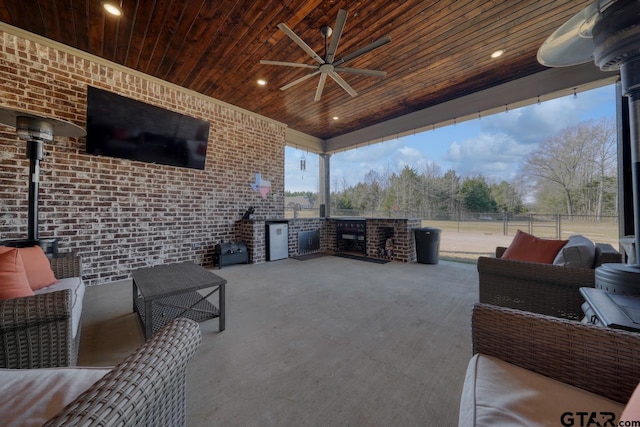 view of patio with exterior kitchen, ceiling fan, and outdoor lounge area