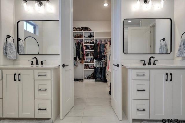 bathroom featuring tile patterned flooring and vanity