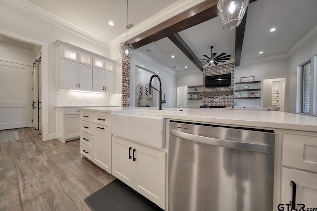 kitchen featuring dishwasher, decorative backsplash, white cabinetry, ceiling fan, and sink