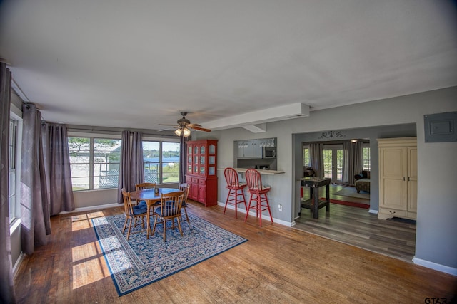 dining area with dark wood-type flooring, ceiling fan, and plenty of natural light