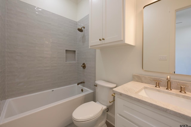 full bathroom featuring tiled shower / bath, toilet, and vanity