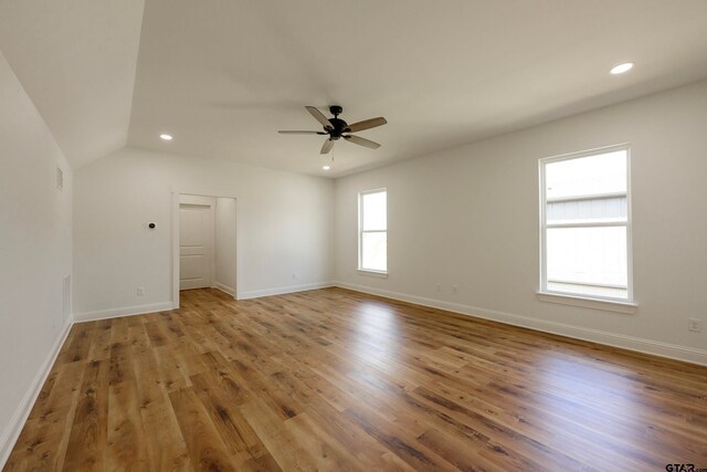 unfurnished room featuring wood-type flooring, ceiling fan, and vaulted ceiling