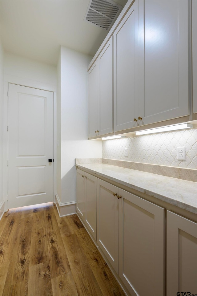 laundry room with light hardwood / wood-style flooring