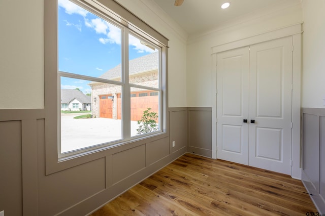 interior space with wood-type flooring and ornamental molding