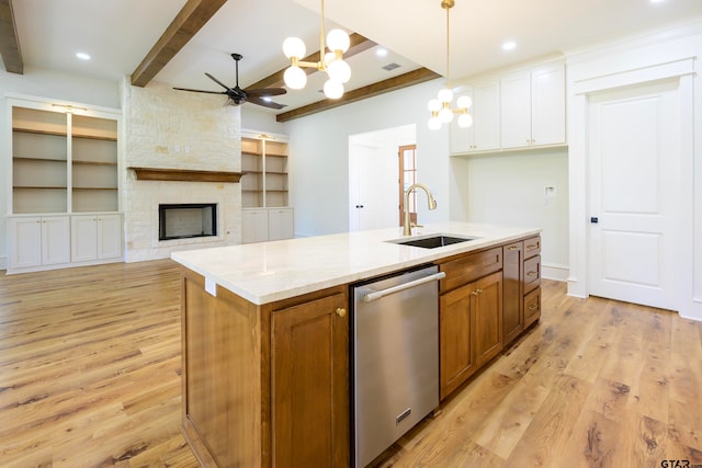 kitchen featuring light hardwood / wood-style floors, white cabinetry, sink, an island with sink, and dishwasher