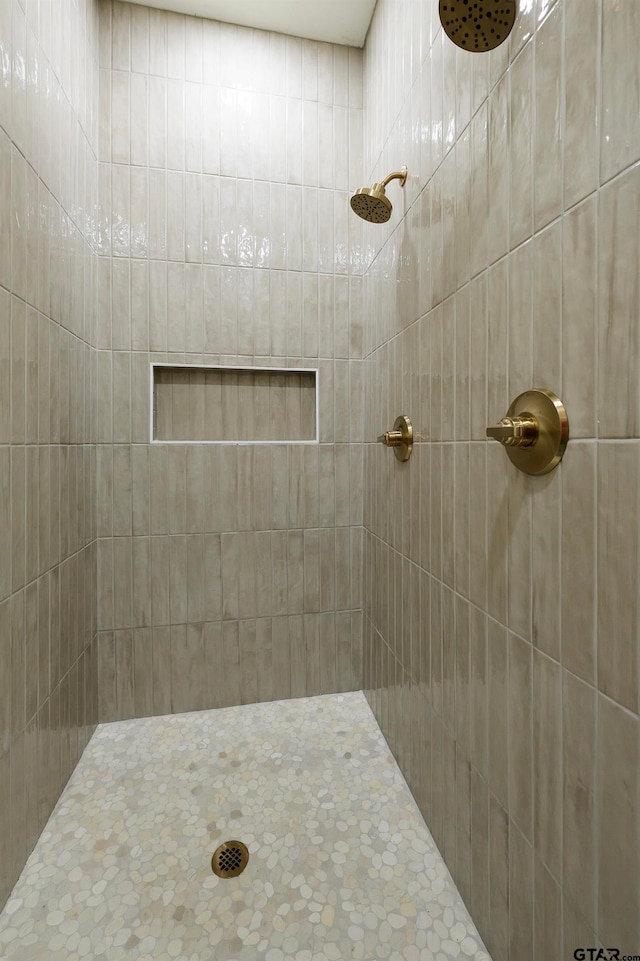 bathroom with tiled shower