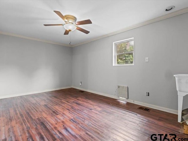 empty room with dark hardwood / wood-style flooring, ceiling fan, and crown molding